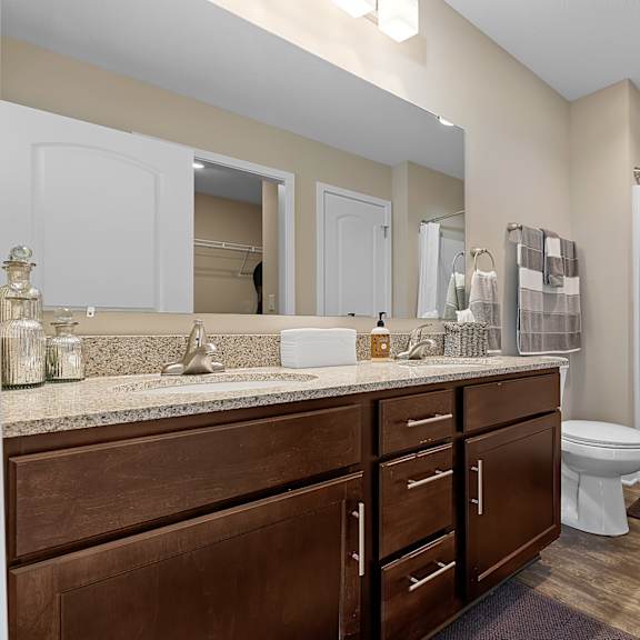 a bathroom with a toilet, sink, and shower.