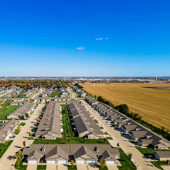 a suburban neighborhood with rows of houses and a clear blue sky.