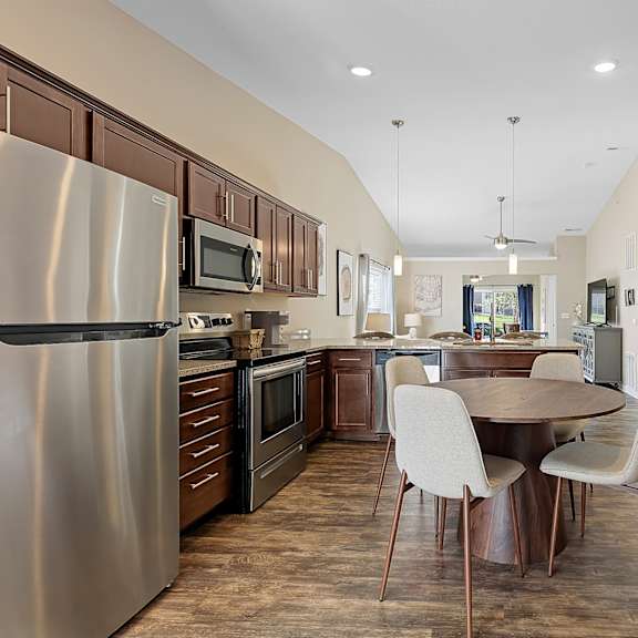 a modern kitchen with a dining table and chairs.