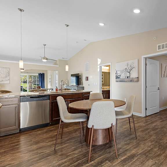 a kitchen with a table and chairs in the middle of the room.