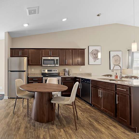 a kitchen with brown cabinets and a white fridge.