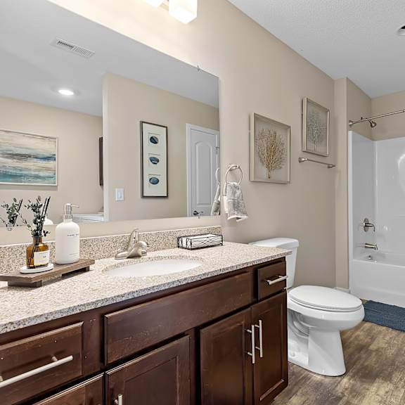 a bathroom with a white toilet and a white shower curtain.