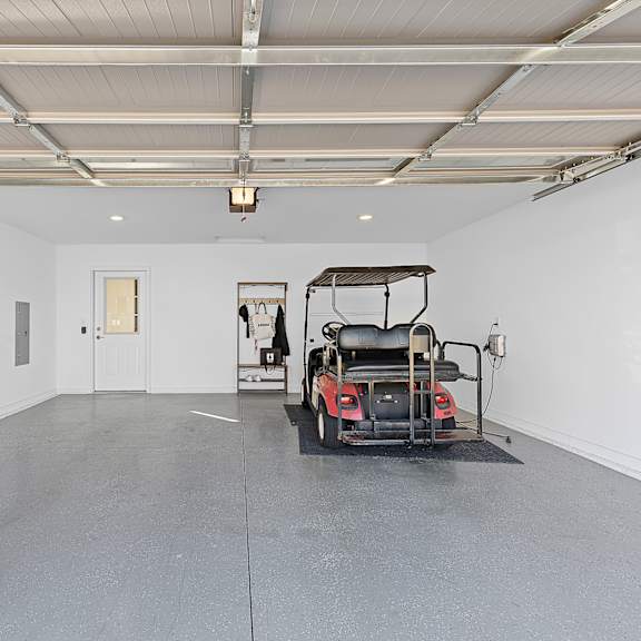 a black mobility scooter is parked in a large, empty room.