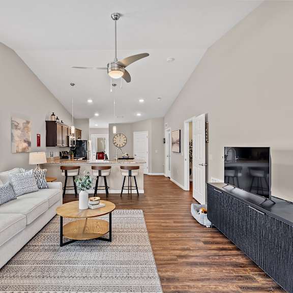 a living room with a white couch and a wooden coffee table.