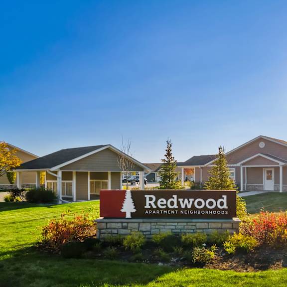 a sign that says redwood in front of some houses.