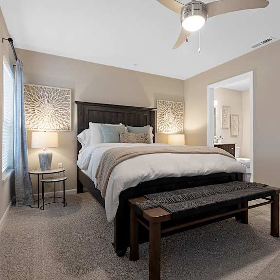 a bedroom with a large bed and a ceiling fan.