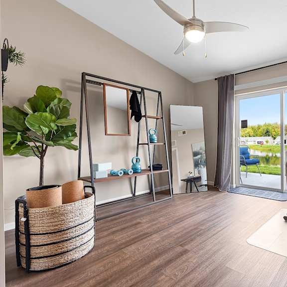 a room with a desk, chair, and mirror.