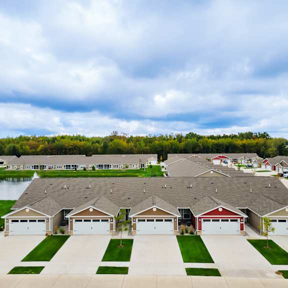a row of houses with garages in front of them.