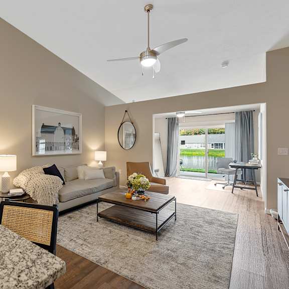 a bedroom with a large bed and a couch with a coffee table in between.
