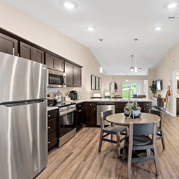 a kitchen with a table and chairs in the middle of the room.