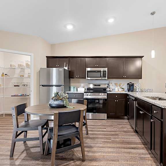 a kitchen with brown cabinets and a white refrigerator.