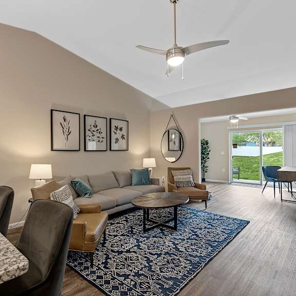 a living room with a couch, chairs, and a rug.