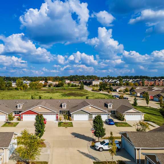 a suburban neighborhood with houses and cars parked in driveways.