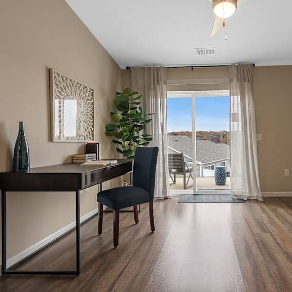 a room with a desk and chair in it.