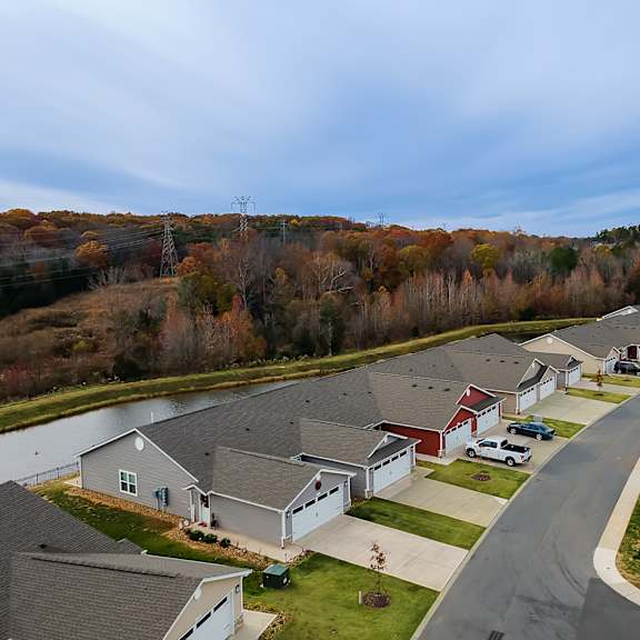 a suburban neighborhood with houses and a road.