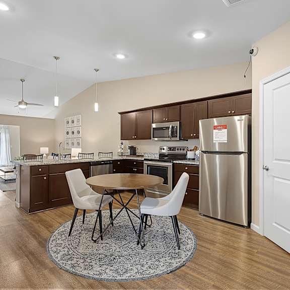 a kitchen with a table and chairs in the middle of the room.