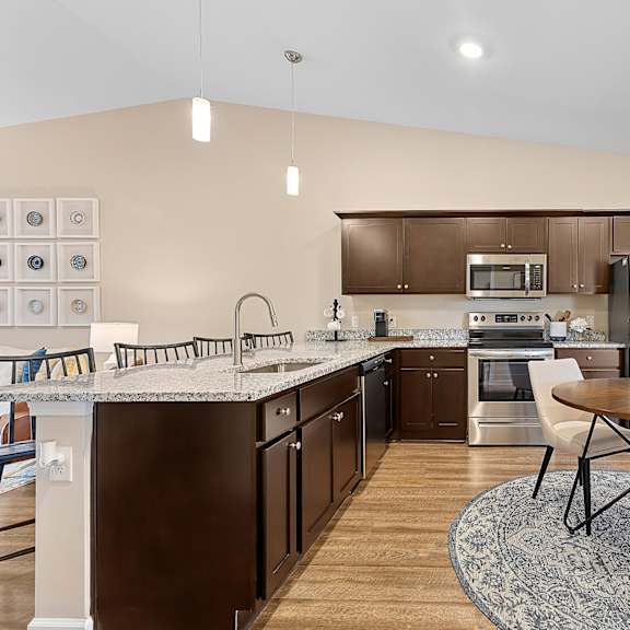 a modern kitchen with a round table and chairs.