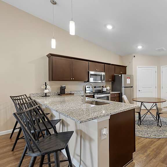a kitchen with a table and chairs.