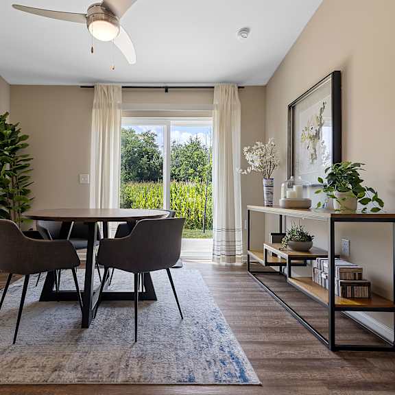 a dining room with a table and chairs.