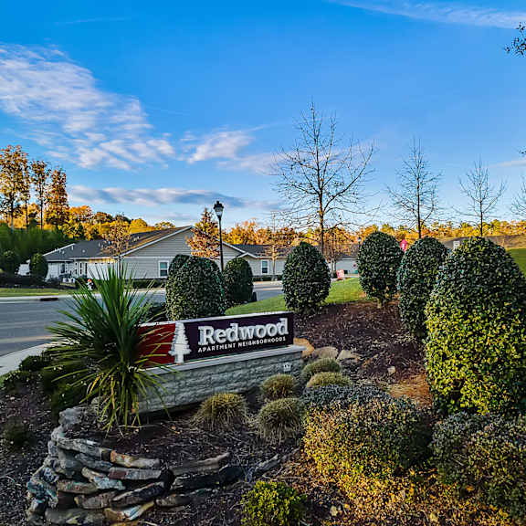 a sign that says redwood in front of a house.
