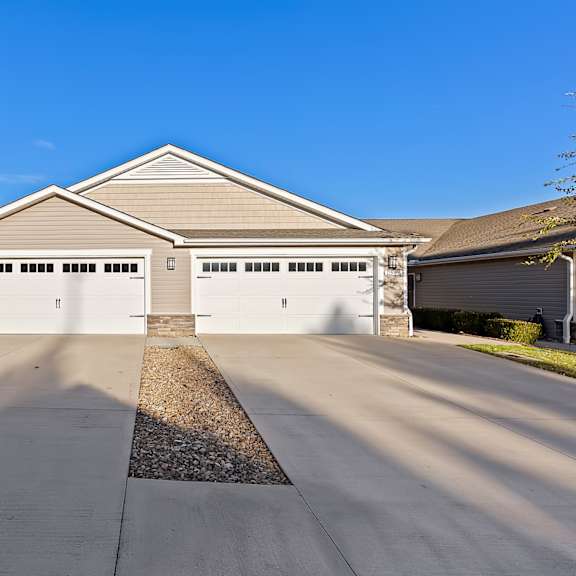a two-car garage is attached to a house.