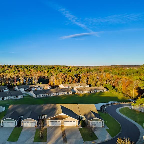 a bird's eye view of a residential area with houses and driveways.
