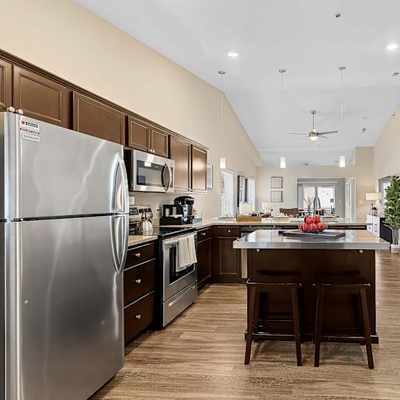 a modern kitchen with a large island and stainless steel appliances.