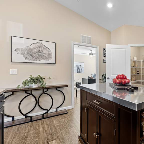 a kitchen with a large island and a framed picture on the wall.