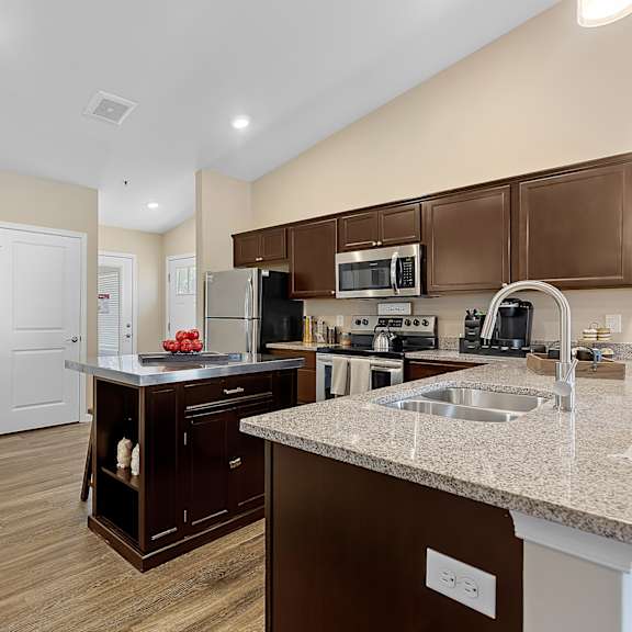 a kitchen with brown cabinets and a white countertop.