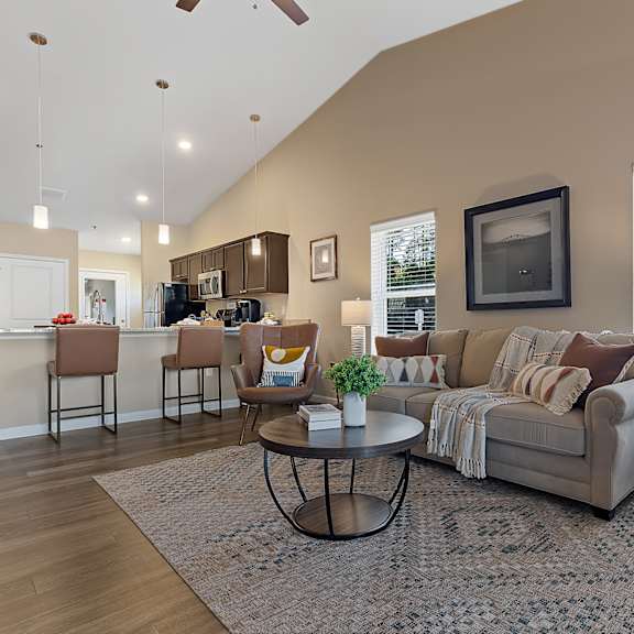 a living room with a couch, chairs, and a coffee table.