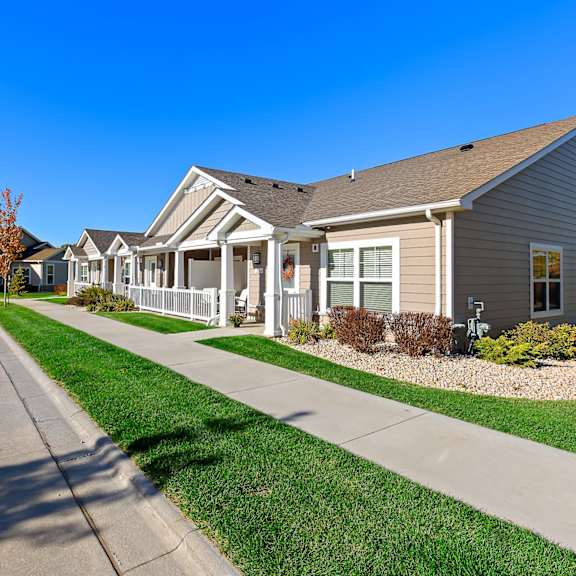 a row of houses with a clear blue sky above them.