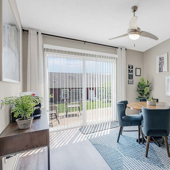 a dining room with a table set for four.