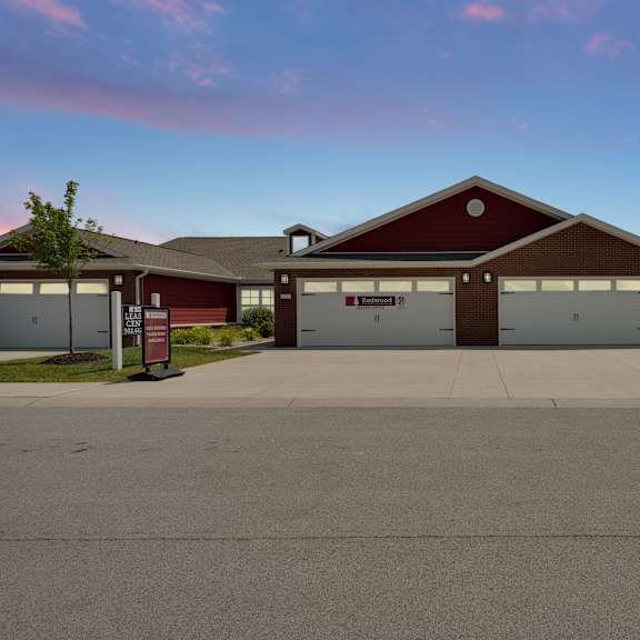 a red building with a garage door sign that says "frontier".