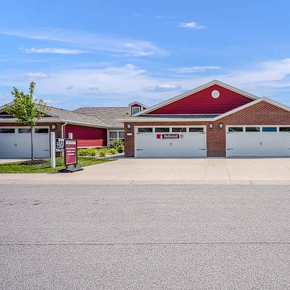 a red building with a white garage door in front.