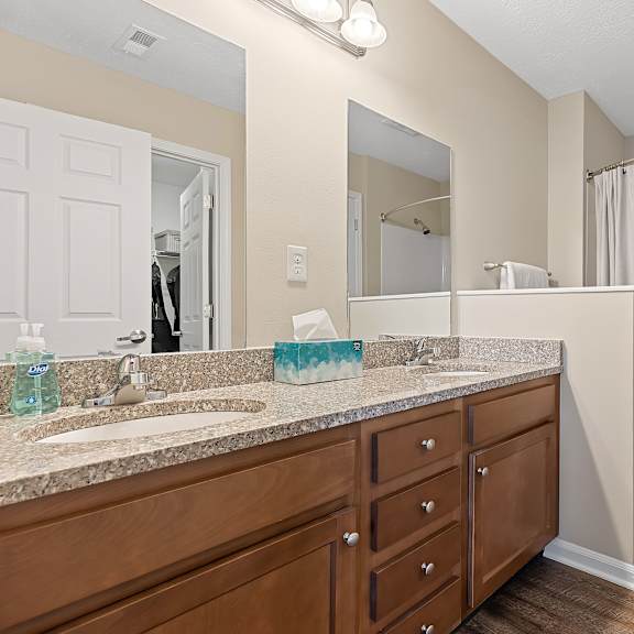 a bathroom with a sink, mirror, and bathtub.