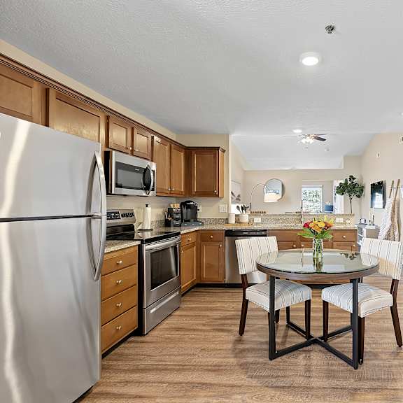 a kitchen with a table and chairs in the middle of the room.