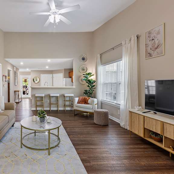 a living room with a beige couch and a coffee table.