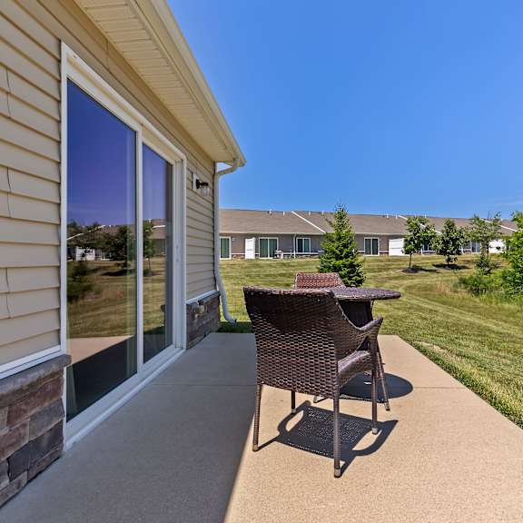 a patio with a chair and table is shown.