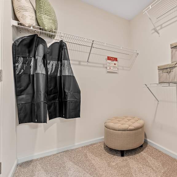 a small closet with a bench and a radiator.