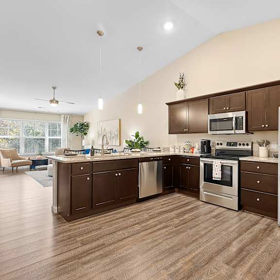 a kitchen with brown cabinets and a stainless steel refrigerator.