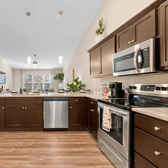 a kitchen with brown cabinets and a stainless steel dishwasher.
