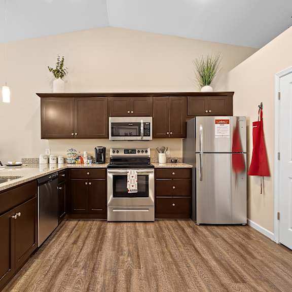 a kitchen with brown cabinets and a white door.