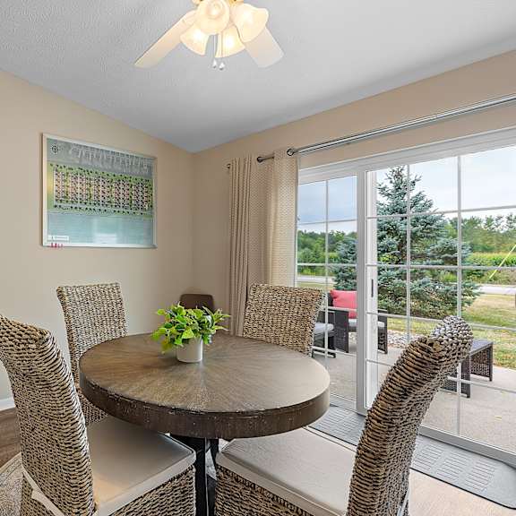 a dining room with a round table and chairs.