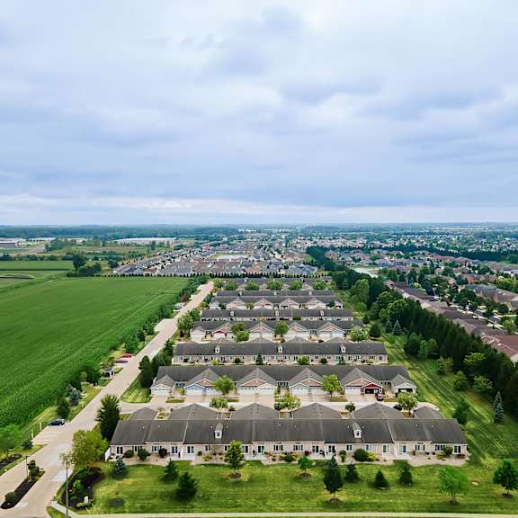 a suburban neighborhood with rows of houses and green lawns.