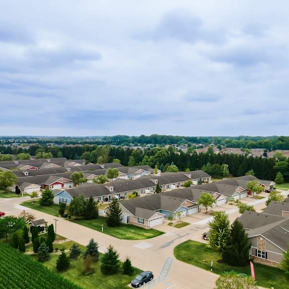 a suburban neighborhood with houses and a car parked on the street.