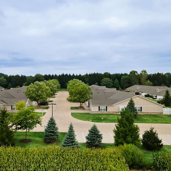a suburban neighborhood with houses and cornfield in the foreground.