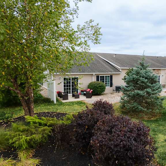 a house with a grey roof and a green lawn.
