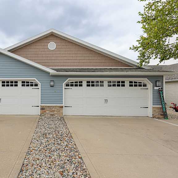 a two-car garage with a stone border in front.