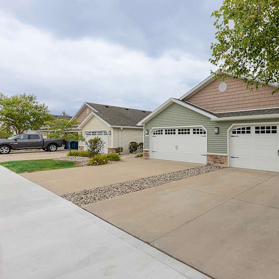 a house with a brown roof and two garages.