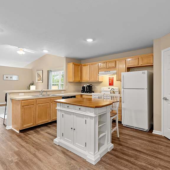 a kitchen with wooden cabinets and a white refrigerator.